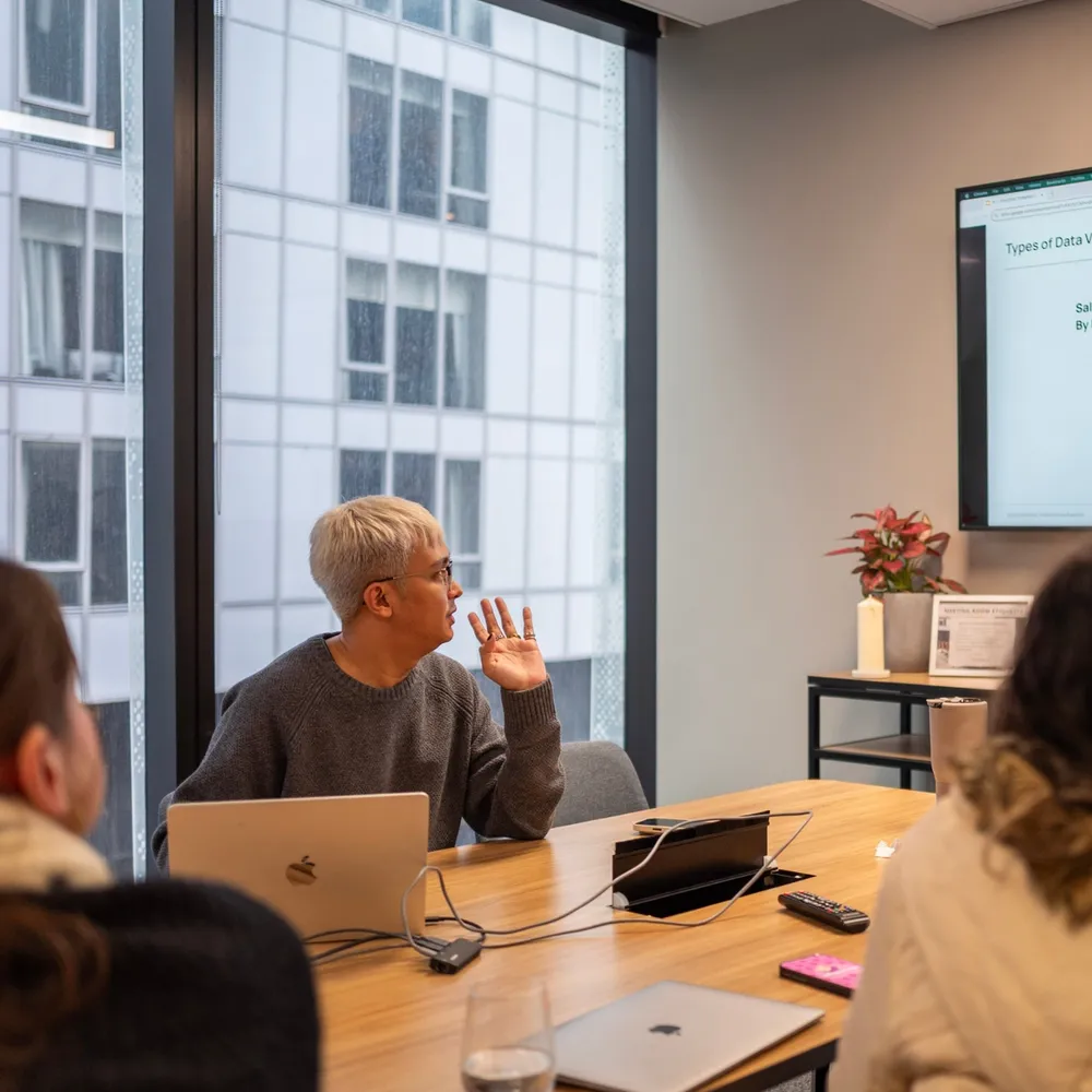 House of Psalm team workshop in the Melbourne office, with a strategist presenting SEO data and campaign insights on screen.