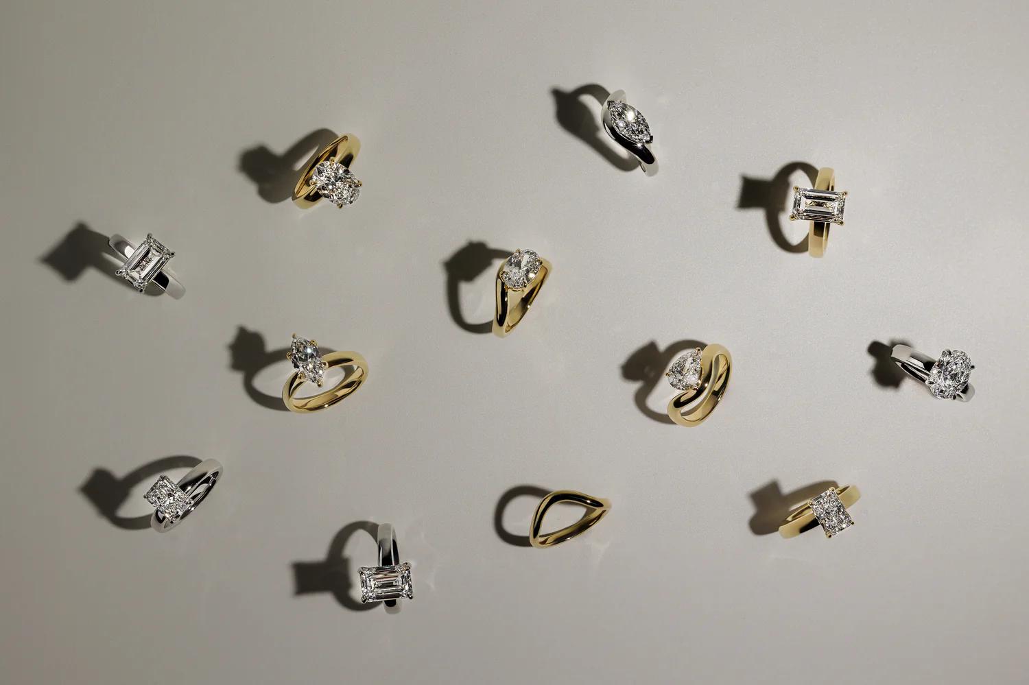 Cullen Jewellery collection of diamond engagement rings in yellow gold and white gold settings, displayed flat on a neutral background.