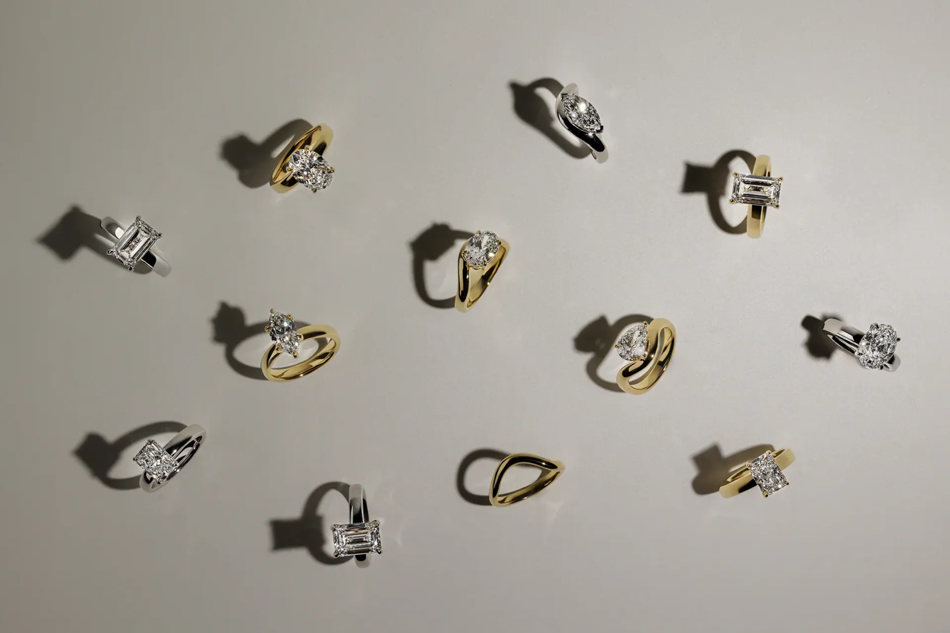 Cullen Jewellery collection of diamond engagement rings in yellow gold and white gold settings, displayed flat on a neutral background.