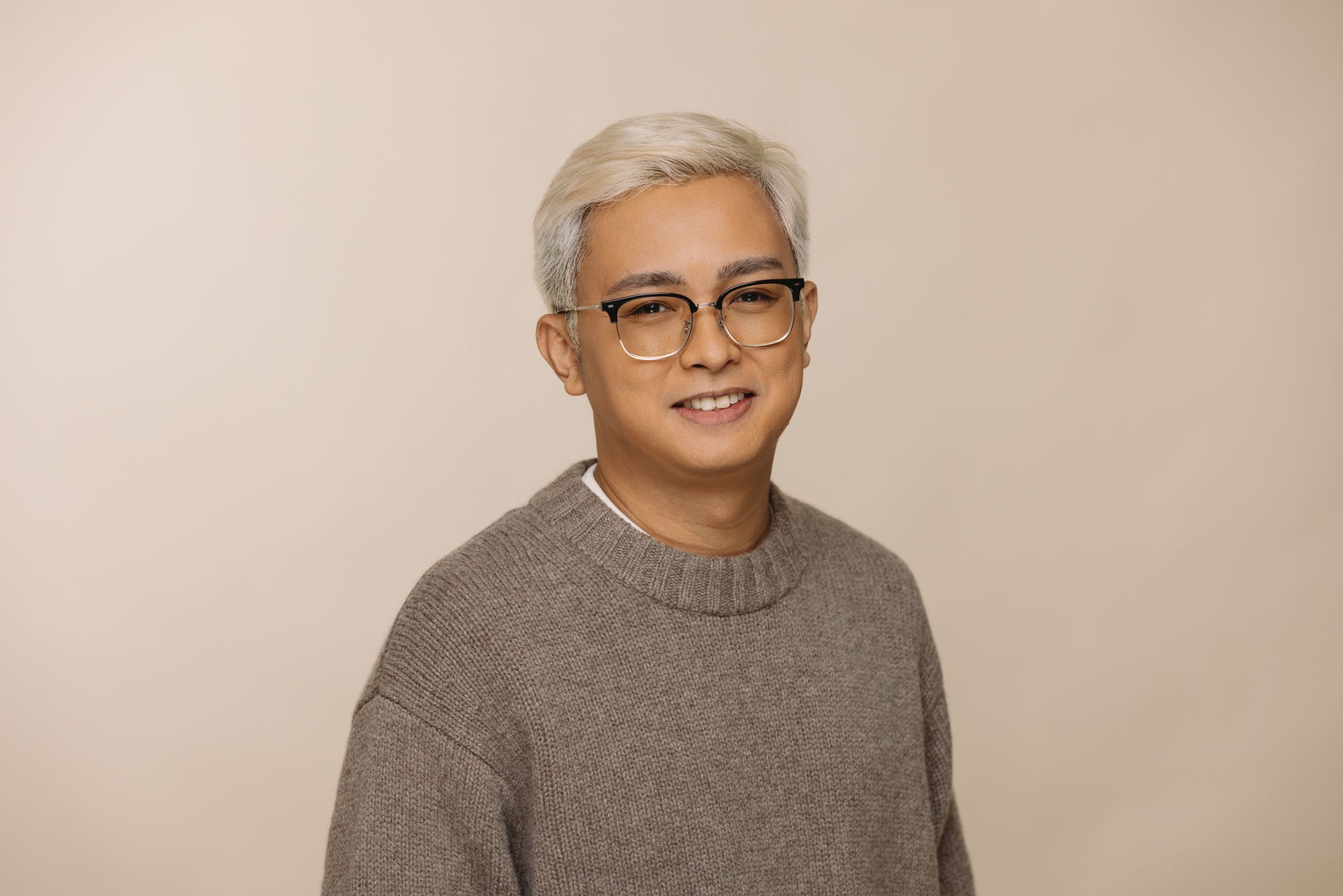 Kris Canimo Head of Strategy at House of Psalm professional headshot wearing light grey jumper