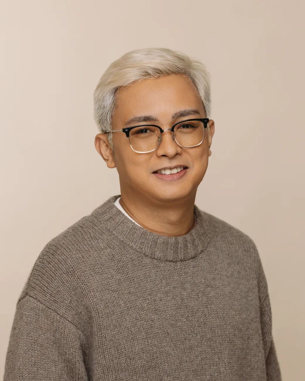 Kris Canimo Head of Strategy at House of Psalm professional headshot wearing light grey jumper