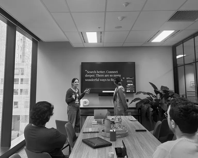 House of Psalm team presenting strategy session in office meeting room with screen display