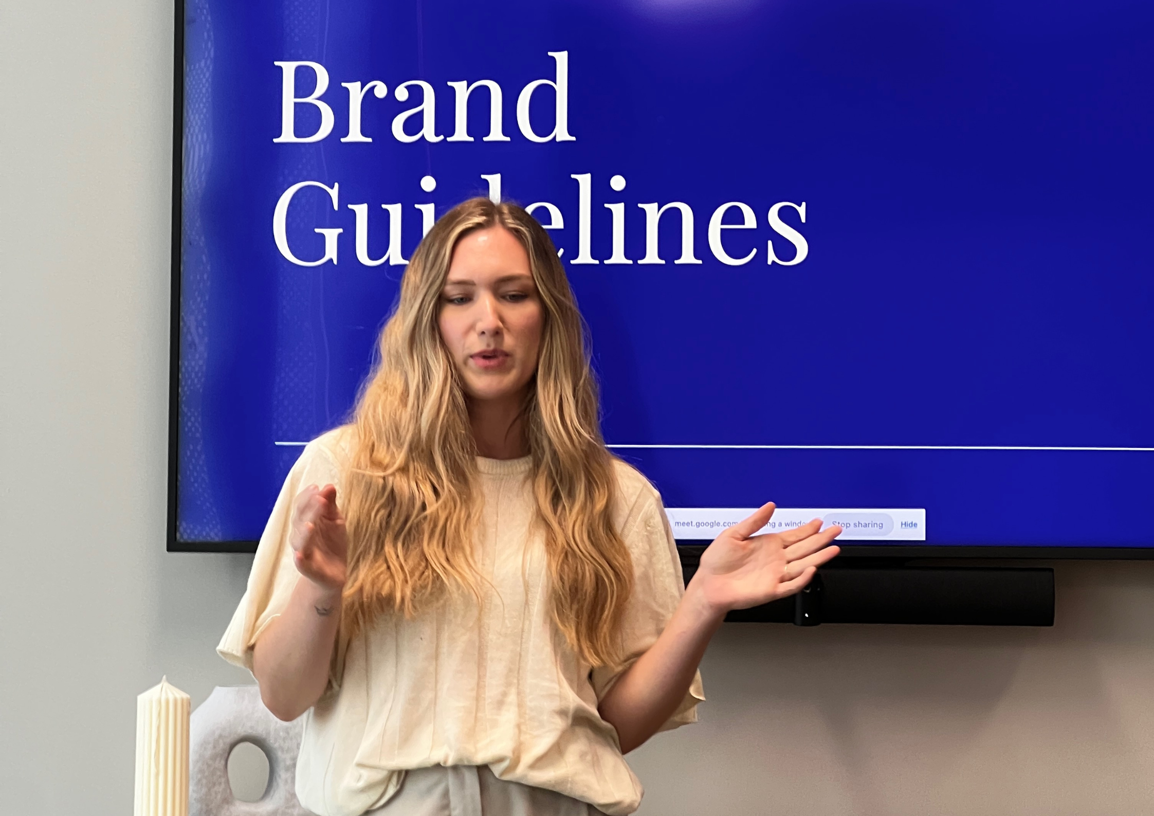 Tara King Stanley presenting House of Psalm Brand Guidelines in front of a screen, showcasing the creative SEO agency’s approach to brand identity.