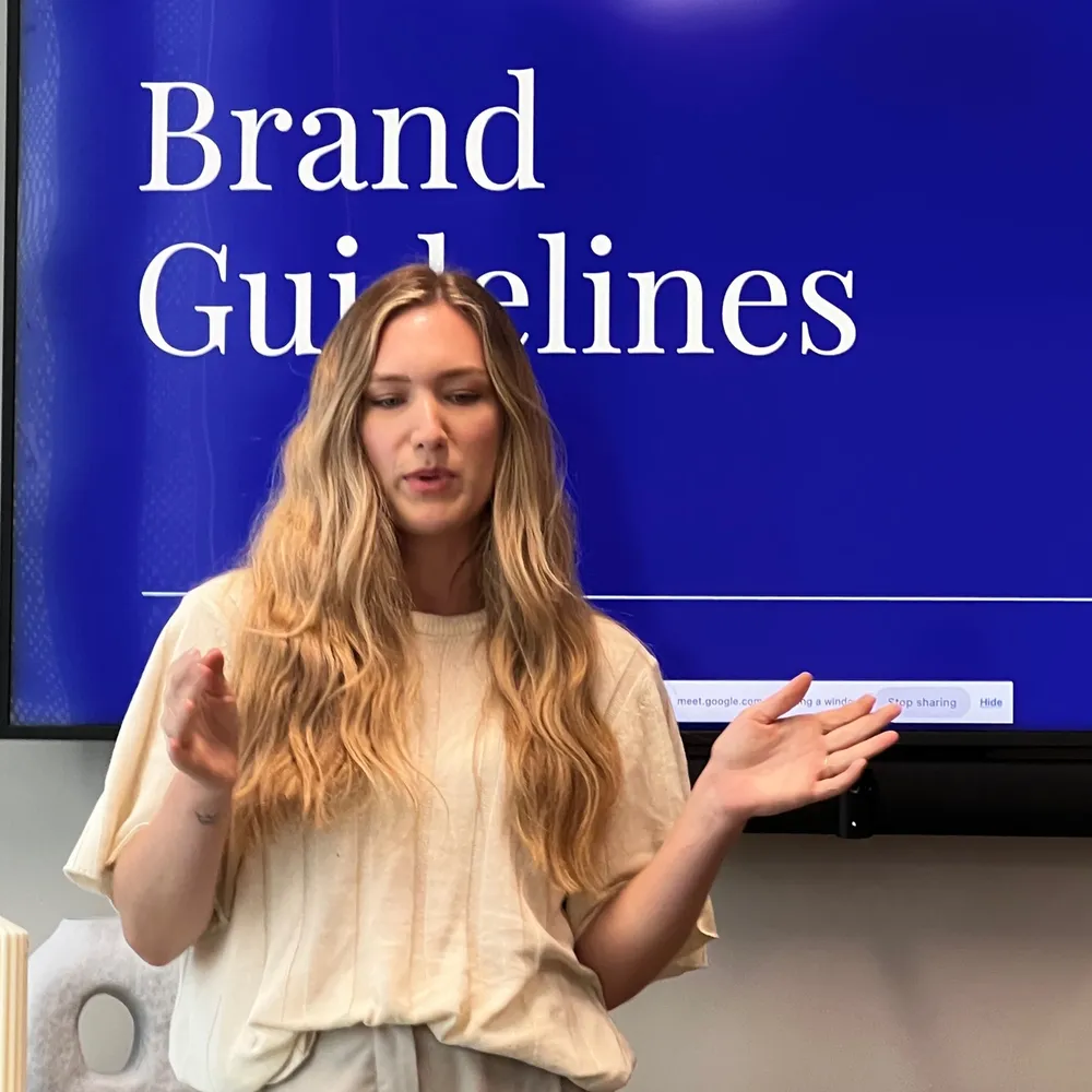 Tara King Stanley presenting House of Psalm Brand Guidelines in front of a screen, showcasing the creative SEO agency’s approach to brand identity.