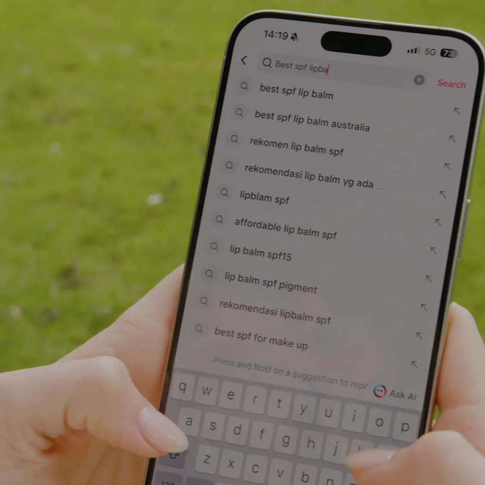 Close-up of a phone screen showing search results for best SPF lip balm in tiktok, highlighting user intent in SEO.
