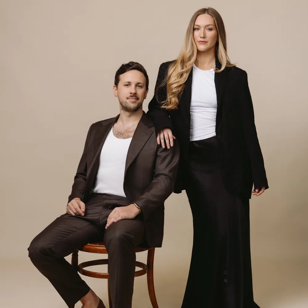 Jacob and Tara King Stanley Directors of House of Psalm professional studio portrait in formal business attire against neutral background