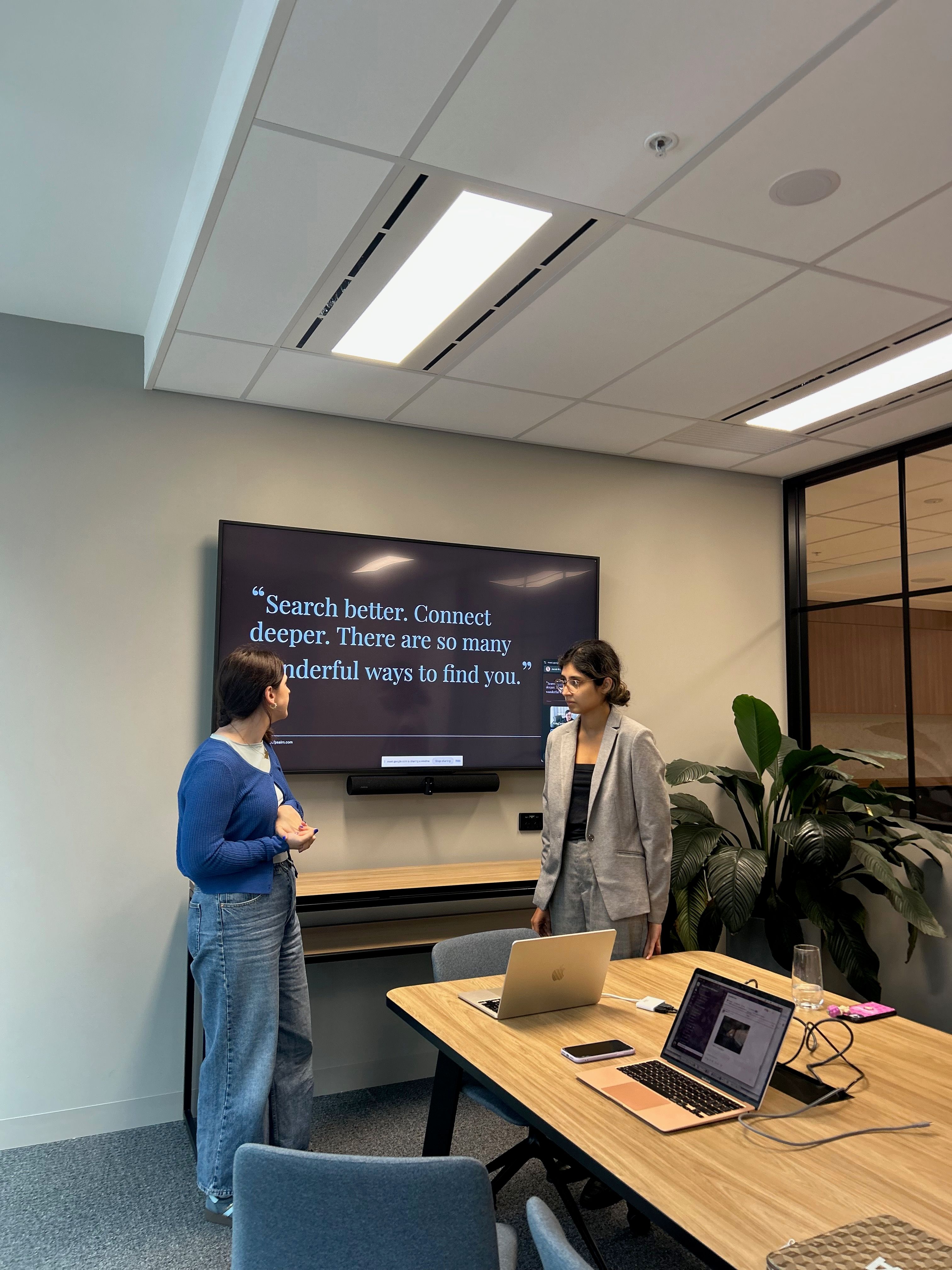 House of Psalm team presenting a PR and SEO strategy in a modern office meeting room, with a screen showing the quote “Search better. Connect deeper. There are so many wonderful ways to find you.”