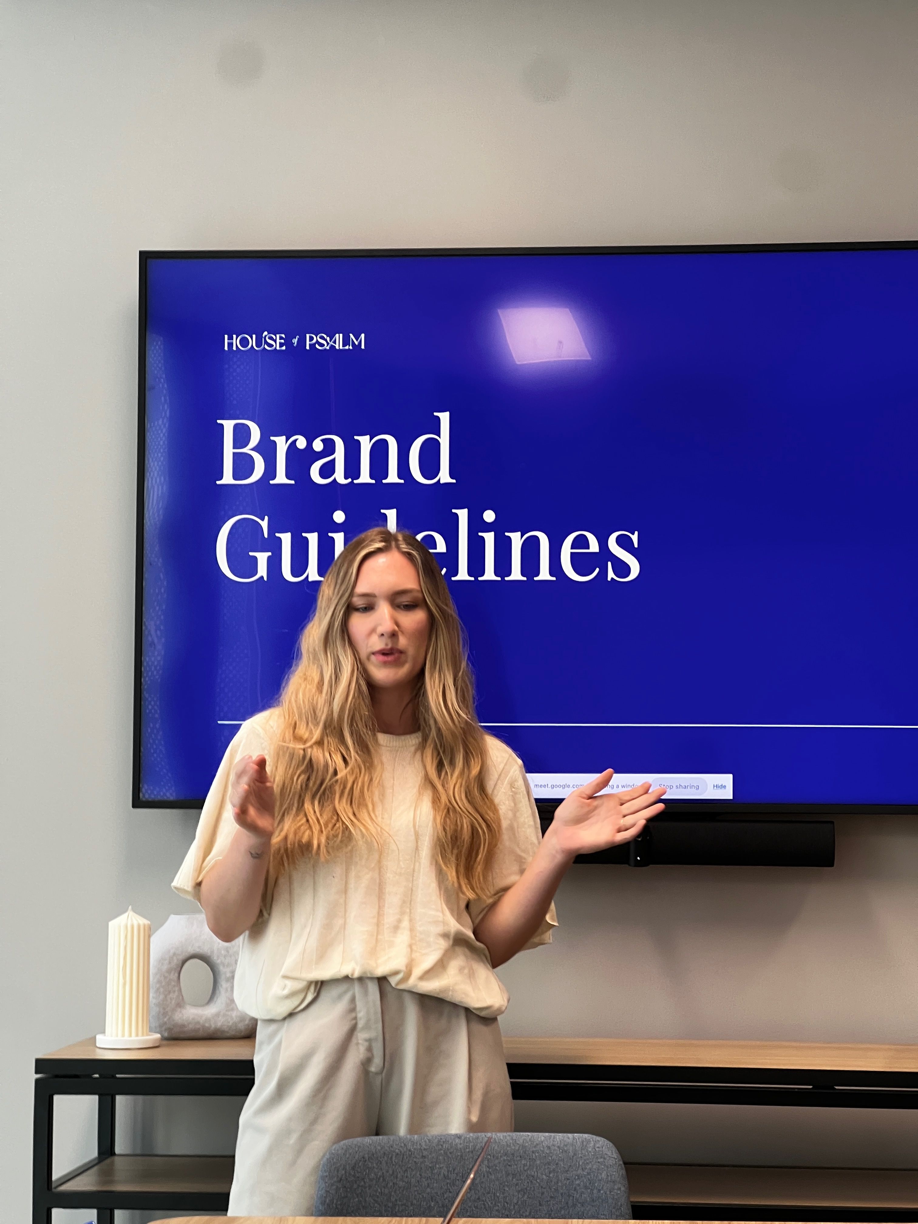 House of Psalm Creative Director presenting brand guidelines about a client to the content writer team in office workshop