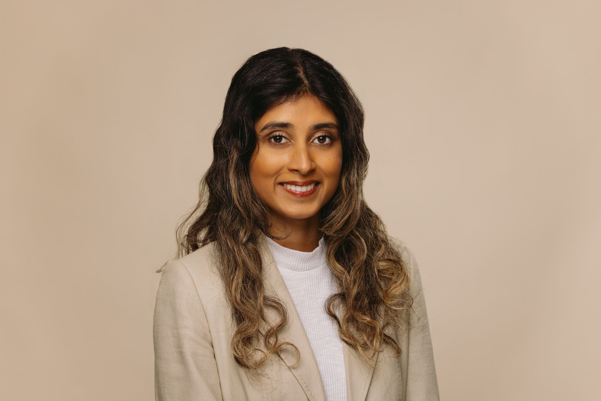 Nikini Kumarasinghe SEO Content Writer at House of Psalm professional headshot wearing beige blazer and white blouse