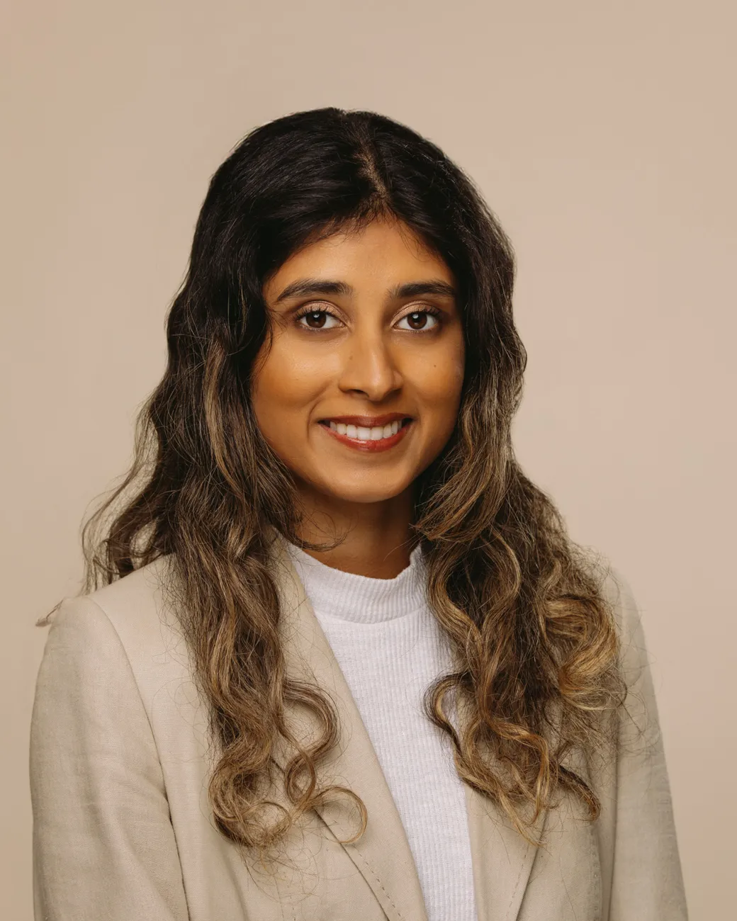 Nikini Kumarasinghe SEO Content Writer at House of Psalm professional headshot wearing beige blazer and white blouse