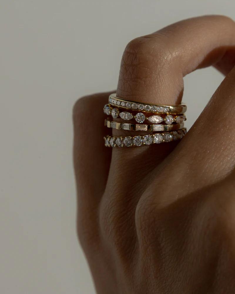 Cullen Jewellery diamond stacking rings in yellow and white gold, styled on a hand to showcase their refined sparkle and versatility.