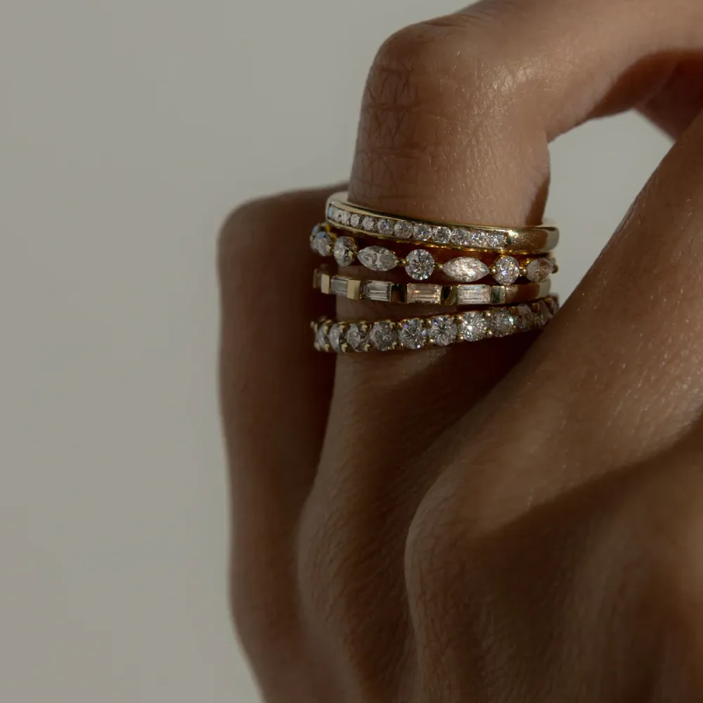 Cullen Jewellery diamond stacking rings in yellow and white gold, styled on a hand to showcase their refined sparkle and versatility.
