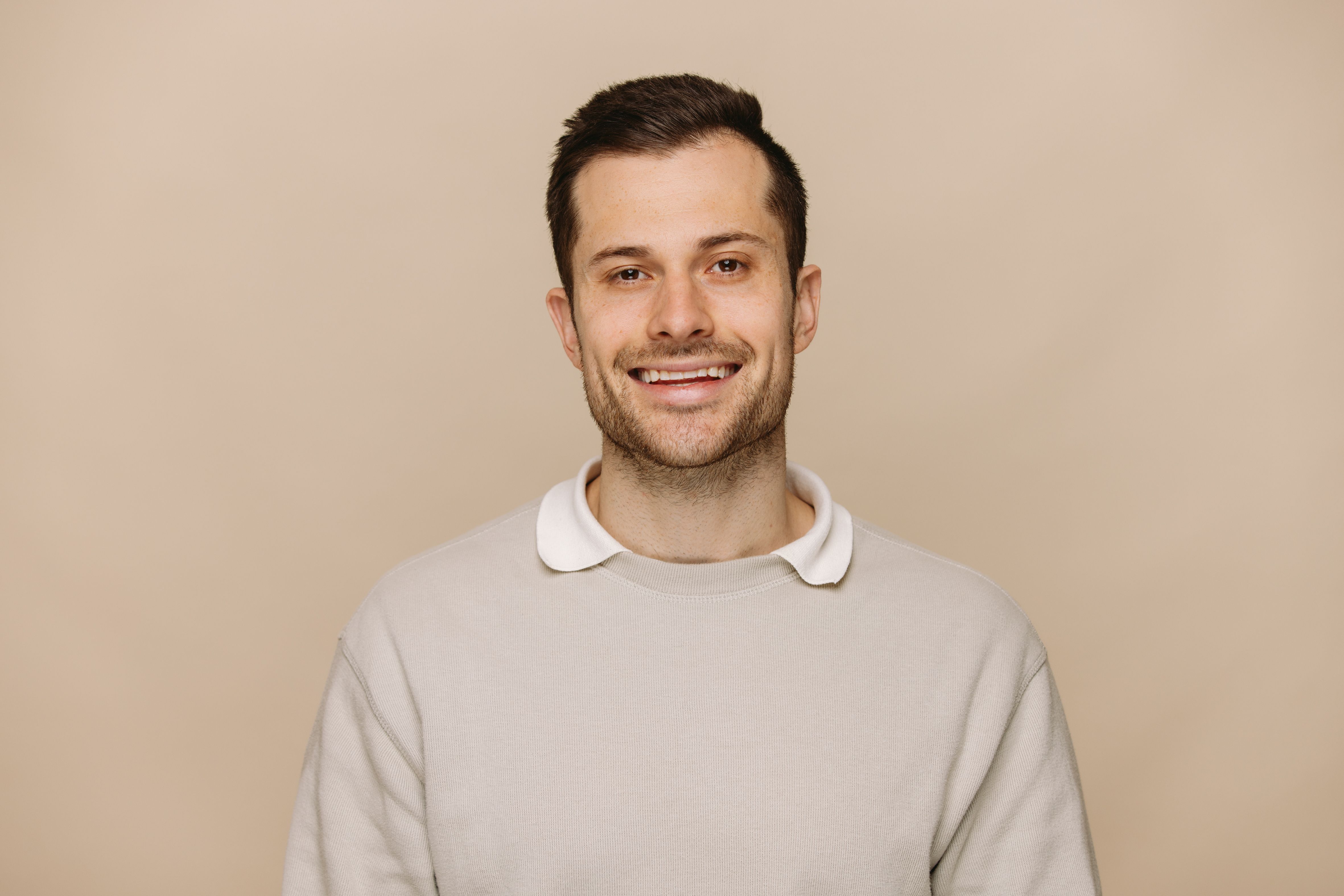 Daniel Jones SEO Specialist at House of Psalm professional headshot wearing white long sleeve top