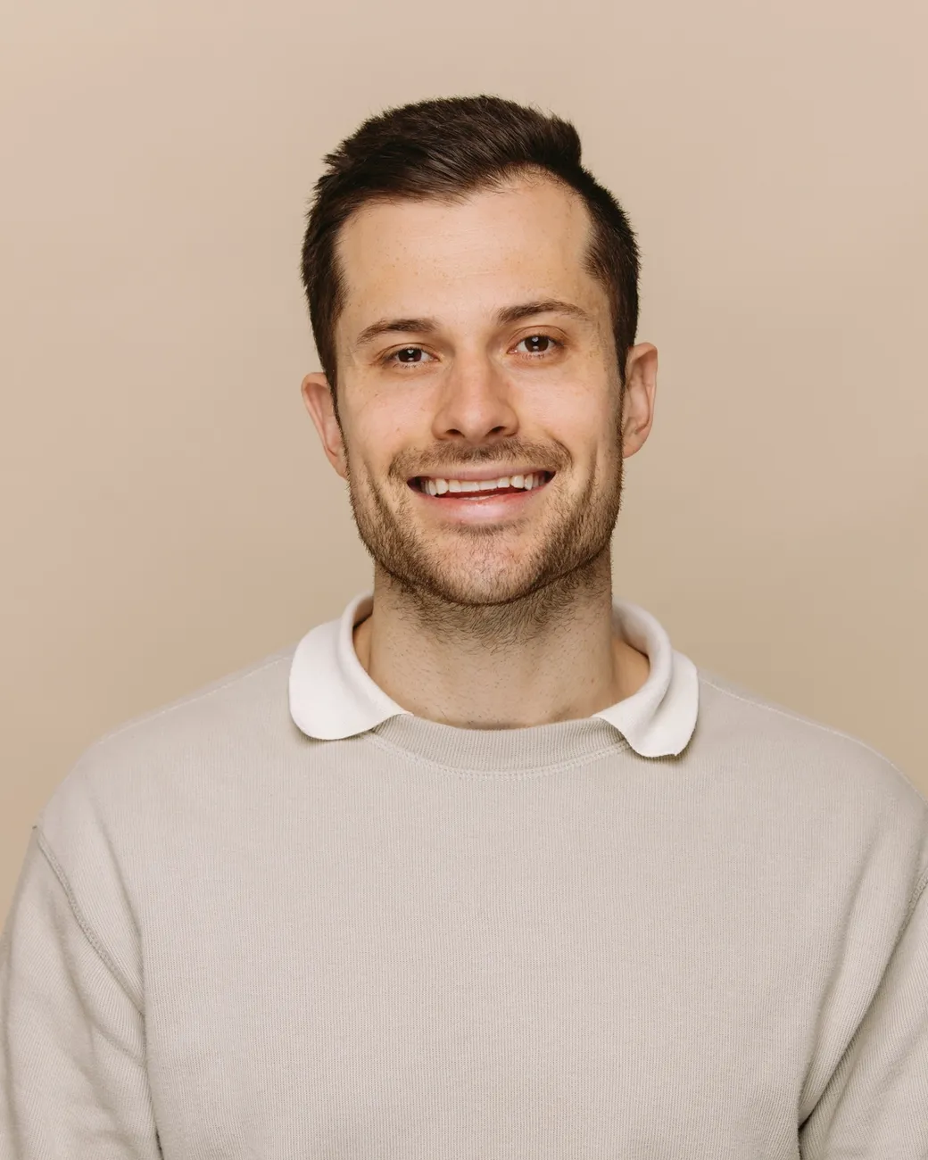 Daniel Jones SEO Specialist at House of Psalm professional headshot wearing white long sleeve top