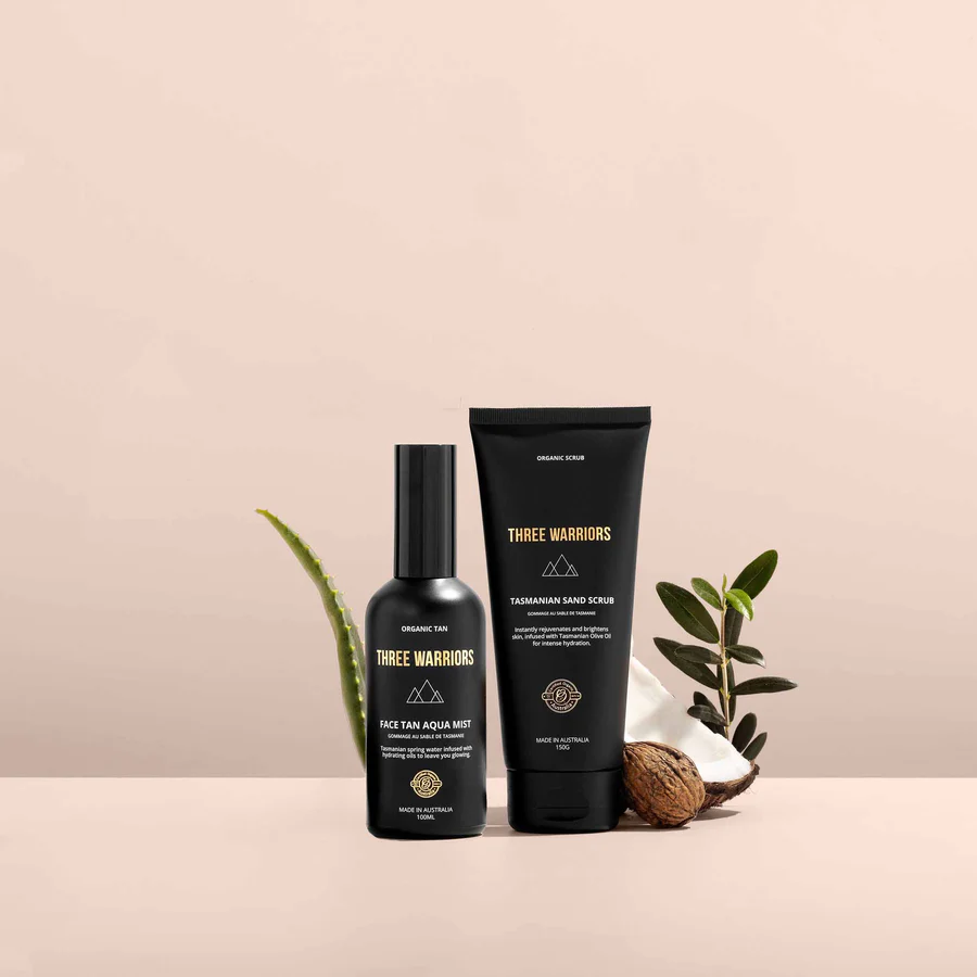 Three Warriors skincare products styled with aloe, coconut, and natural ingredients on a neutral backdrop