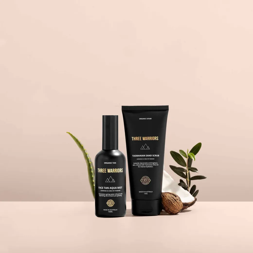 Three Warriors skincare products styled with aloe, coconut, and natural ingredients on a neutral backdrop