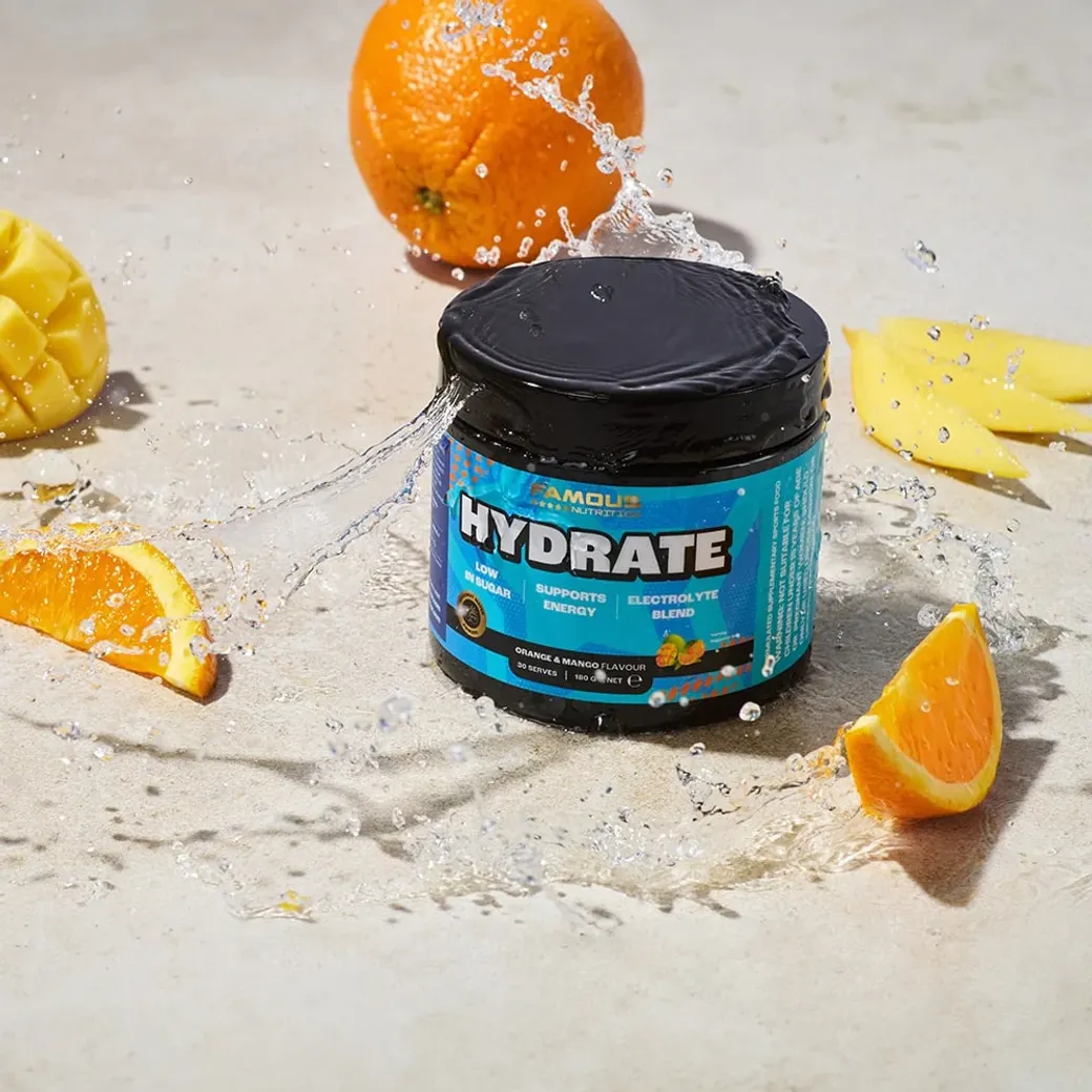 Famous Hydrate electrolyte energy powder with orange and mango flavour, splashing water for a refreshing effect.
