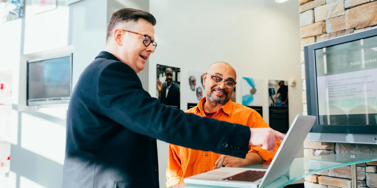 Two business professionals shaking hands, illustrating a meeting generated through B2B direct mail outreach.
