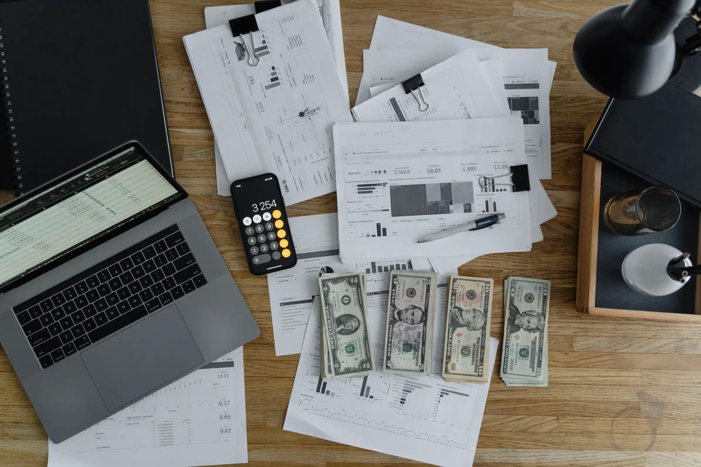 Overhead view of printed materials and a laptop on a desk, illustrating B2B direct mail campaign planning.