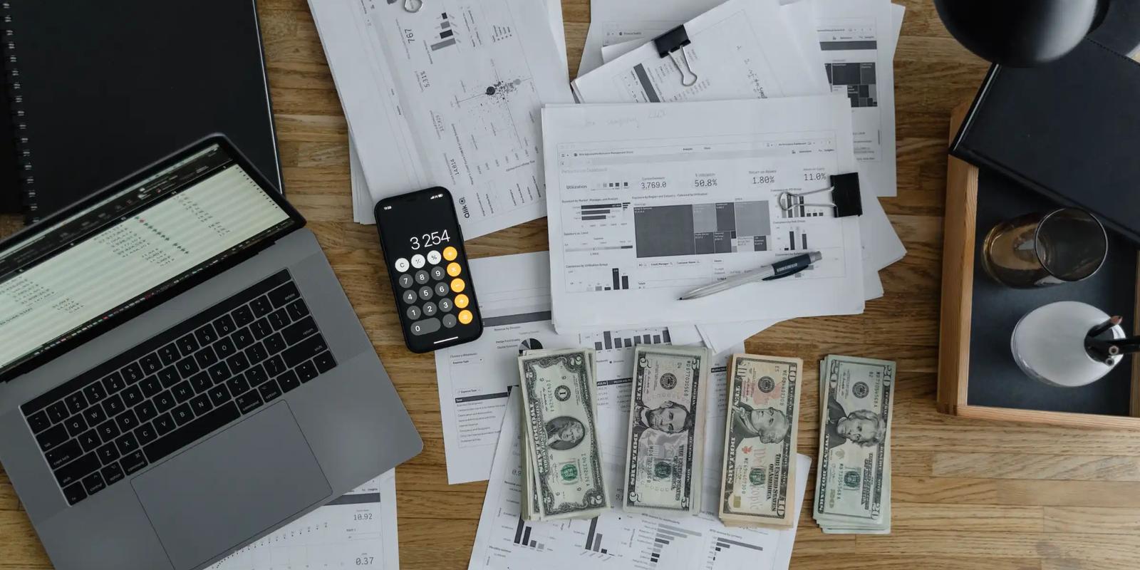 Overhead view of printed materials and a laptop on a desk, illustrating B2B direct mail campaign planning.