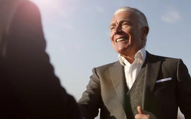 Business professionals outside an office, representing decision-makers targeted by B2B postcard campaigns.