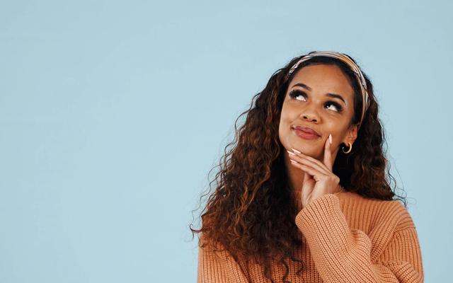 Marketing woman considering B2B and B2C direct mail statistics on open rates, scan rates, leads, conversions, and sales.