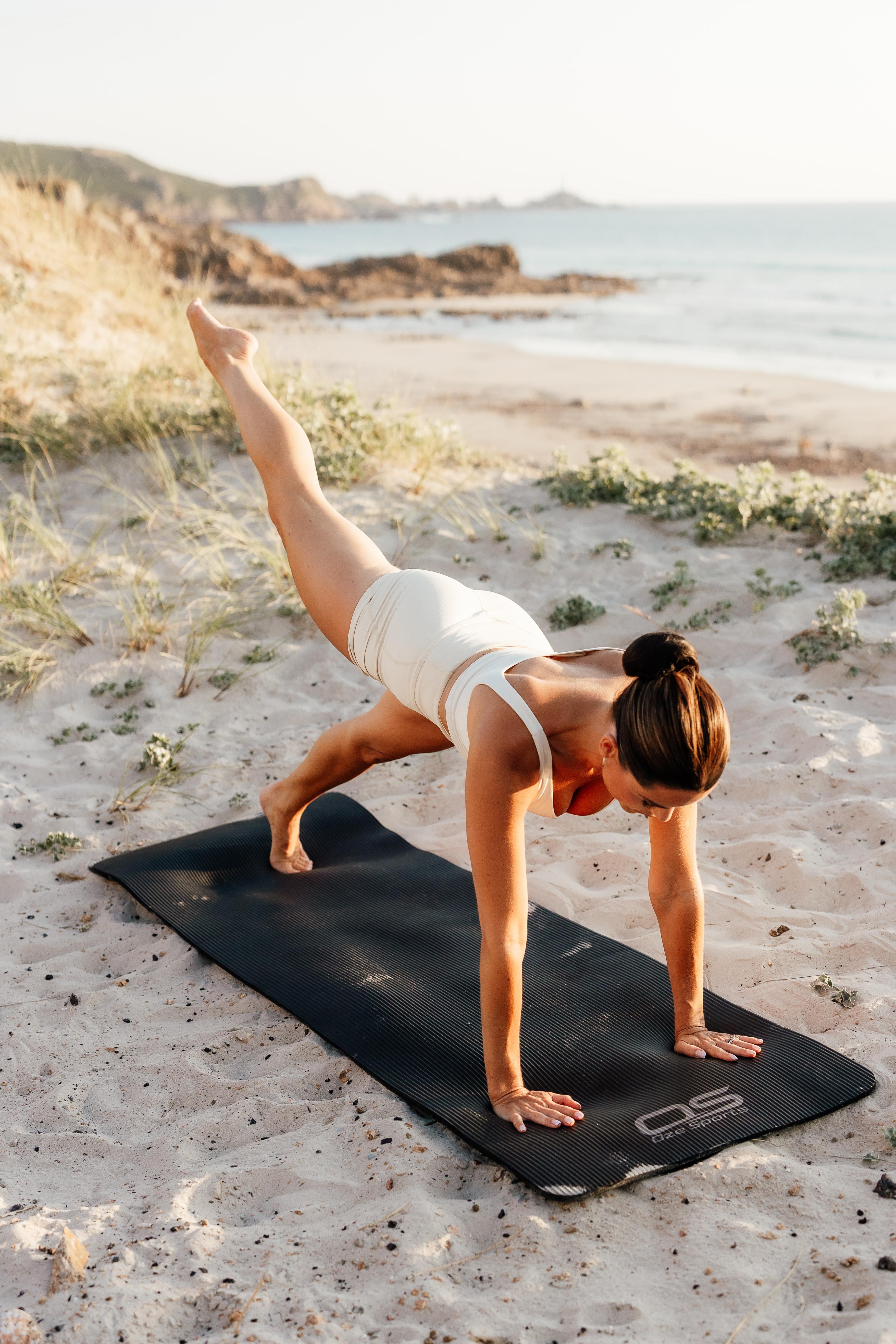 Tabitha doing yoga on the beach