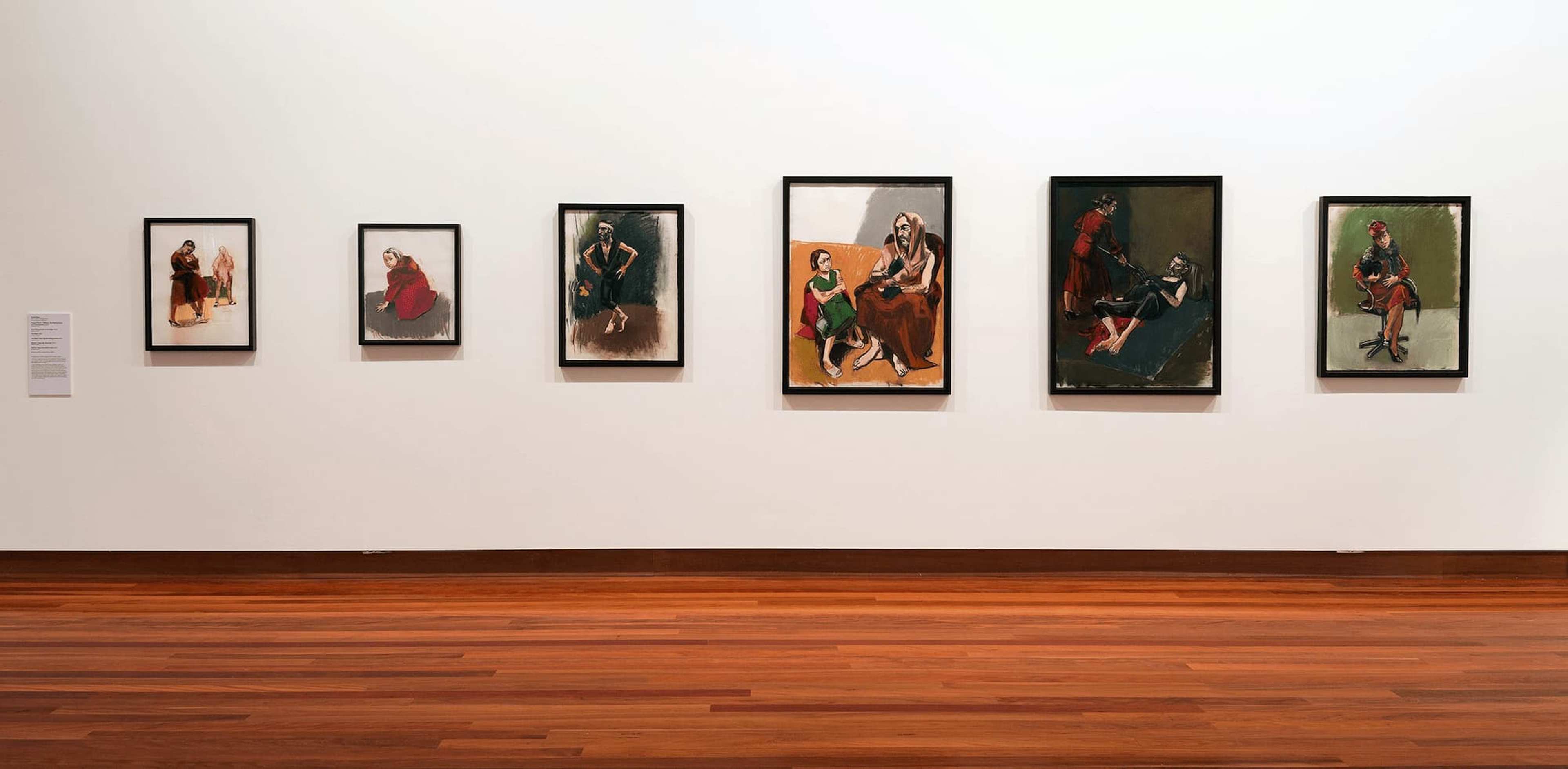 A series of paintings on a gallery wall by Paula Rego re-interpreting the story of Little Red Riding Hood