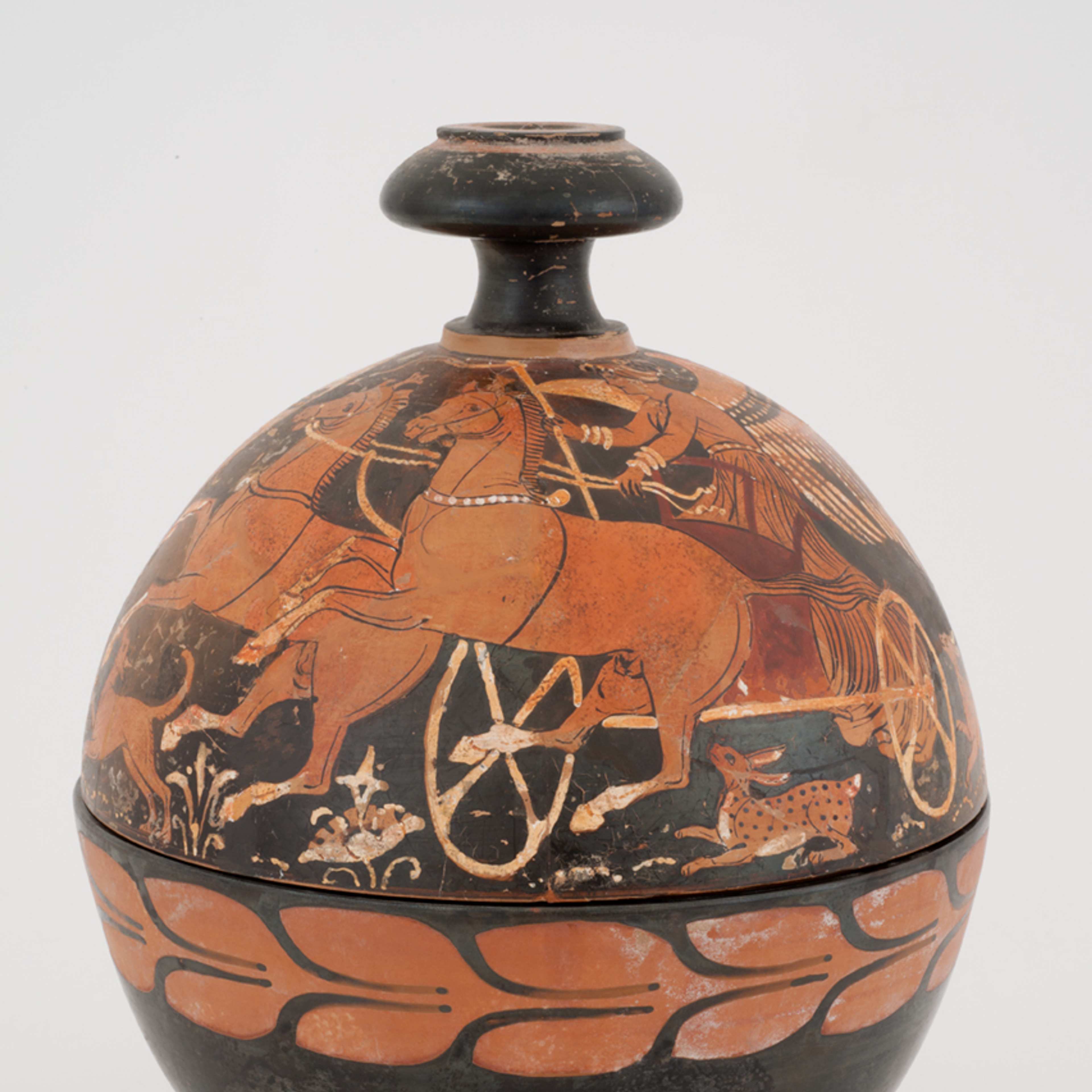 Ancient spherical vessel with red-on-black figures of horses and a chariot driver