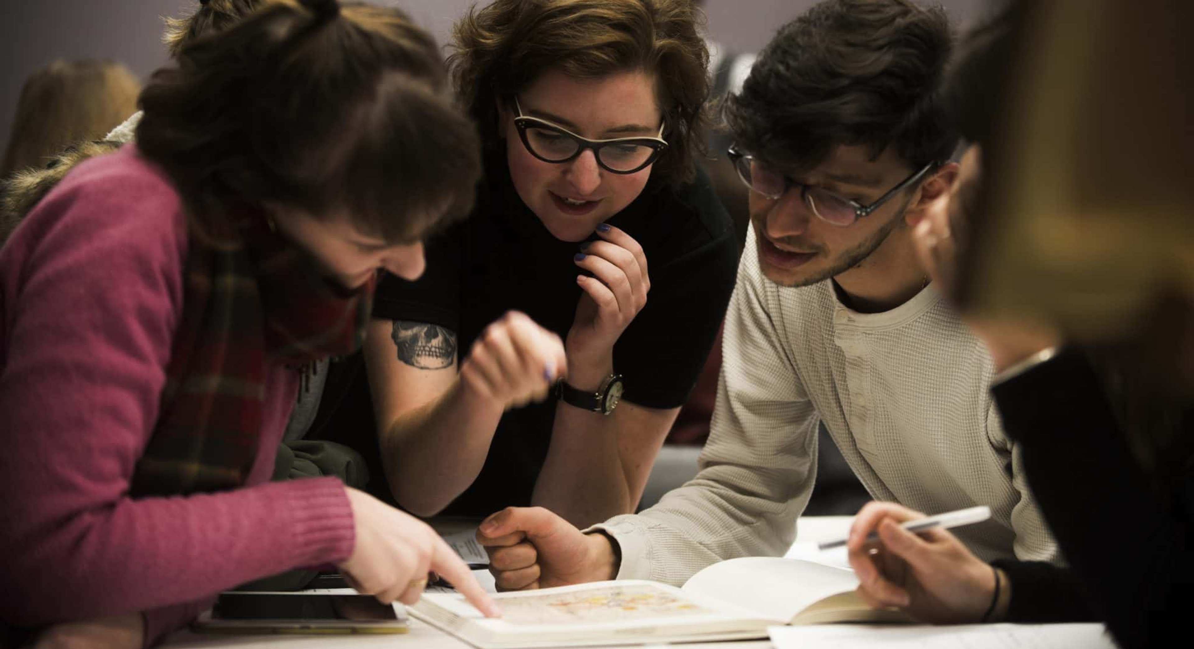 tertiary students gather around a project