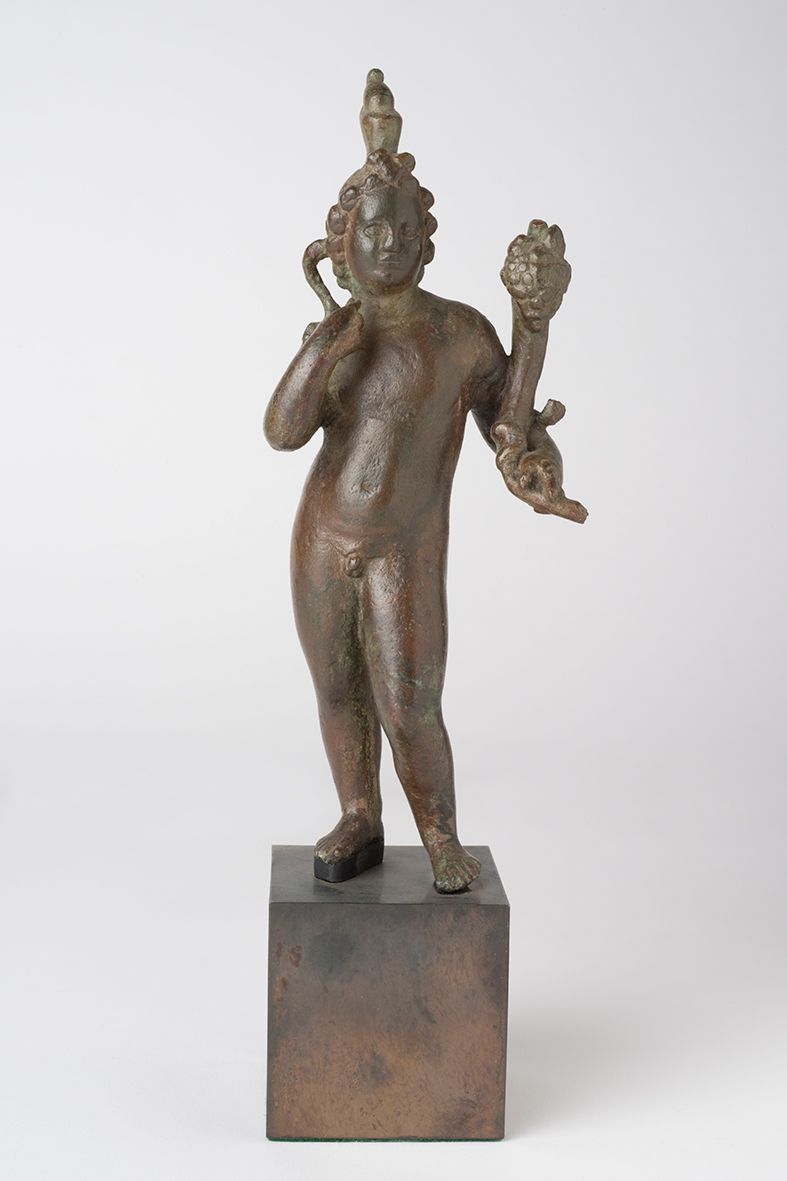 A bronze figurine of a nude figure on a small pedestal