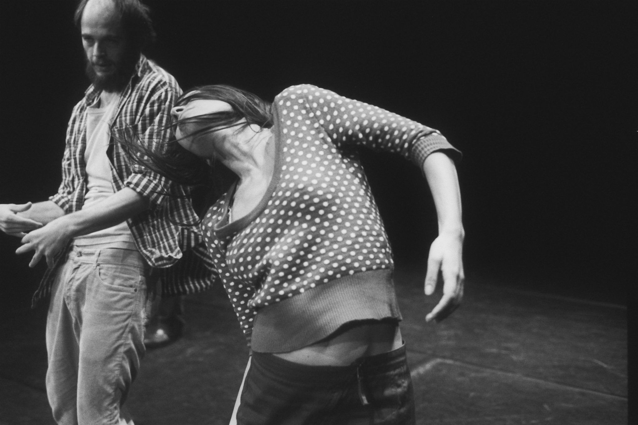 A still from a black and white film showing two people captured mid-dance