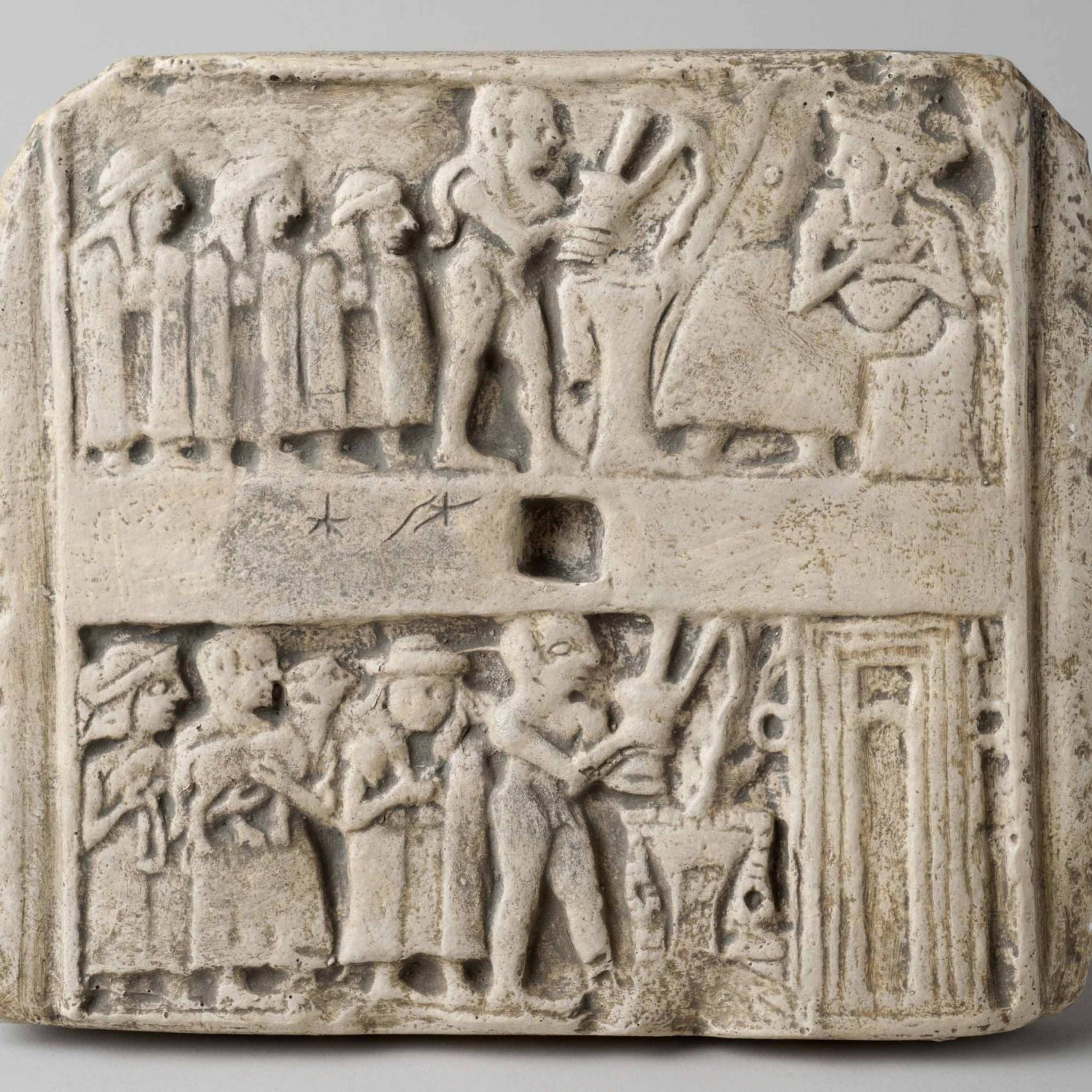 A photograph of an ancient plaque with carved figures lined up in front of another figure on the throne