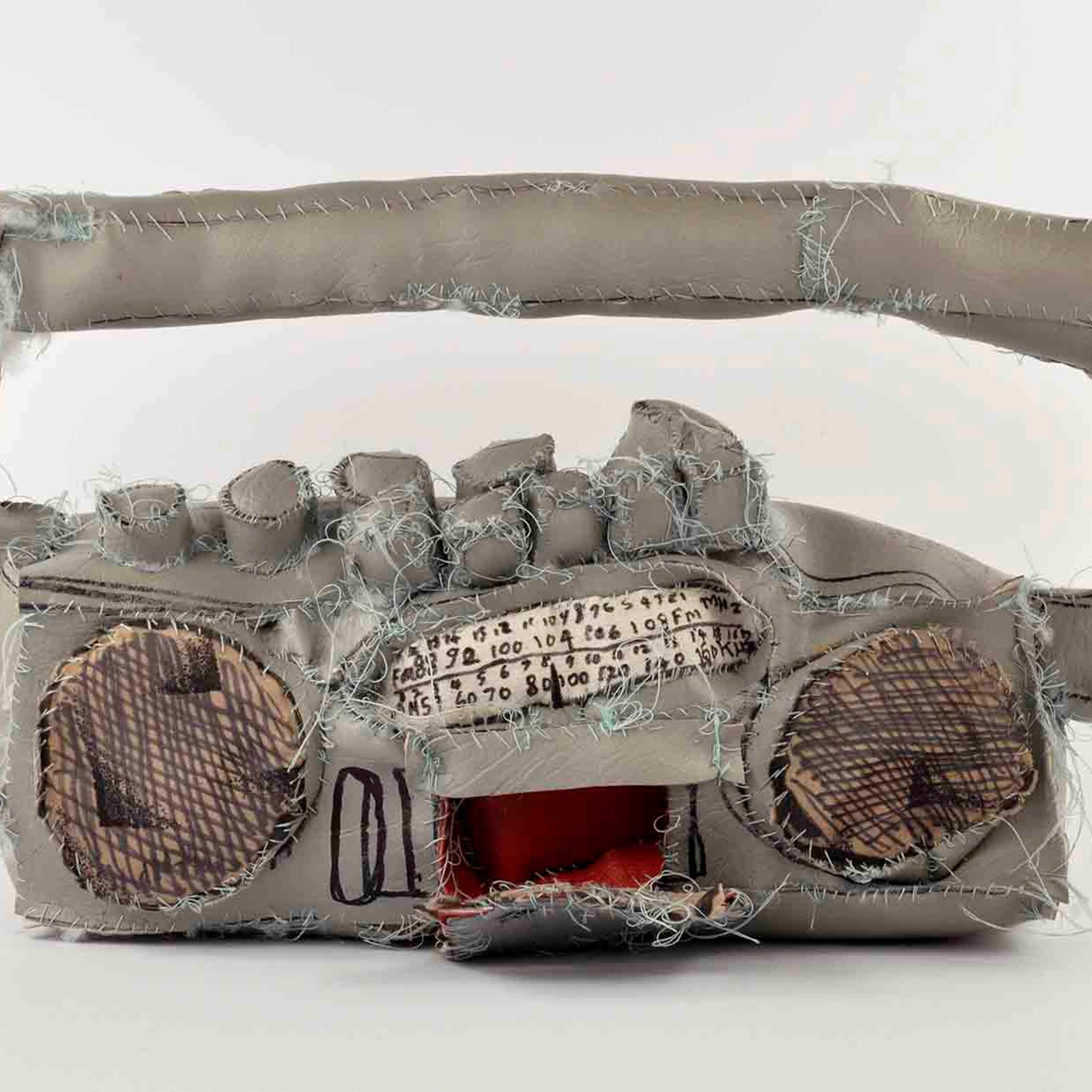 A fabric sculpture of a stereo with a cassette player