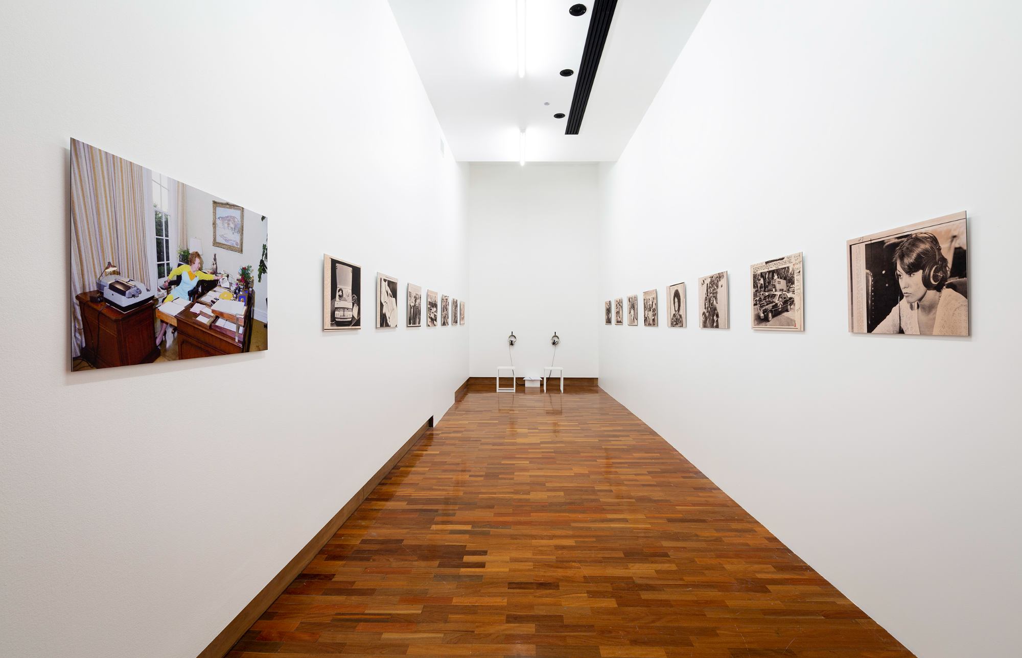 A corridor lined with photographs of different listening scenarios