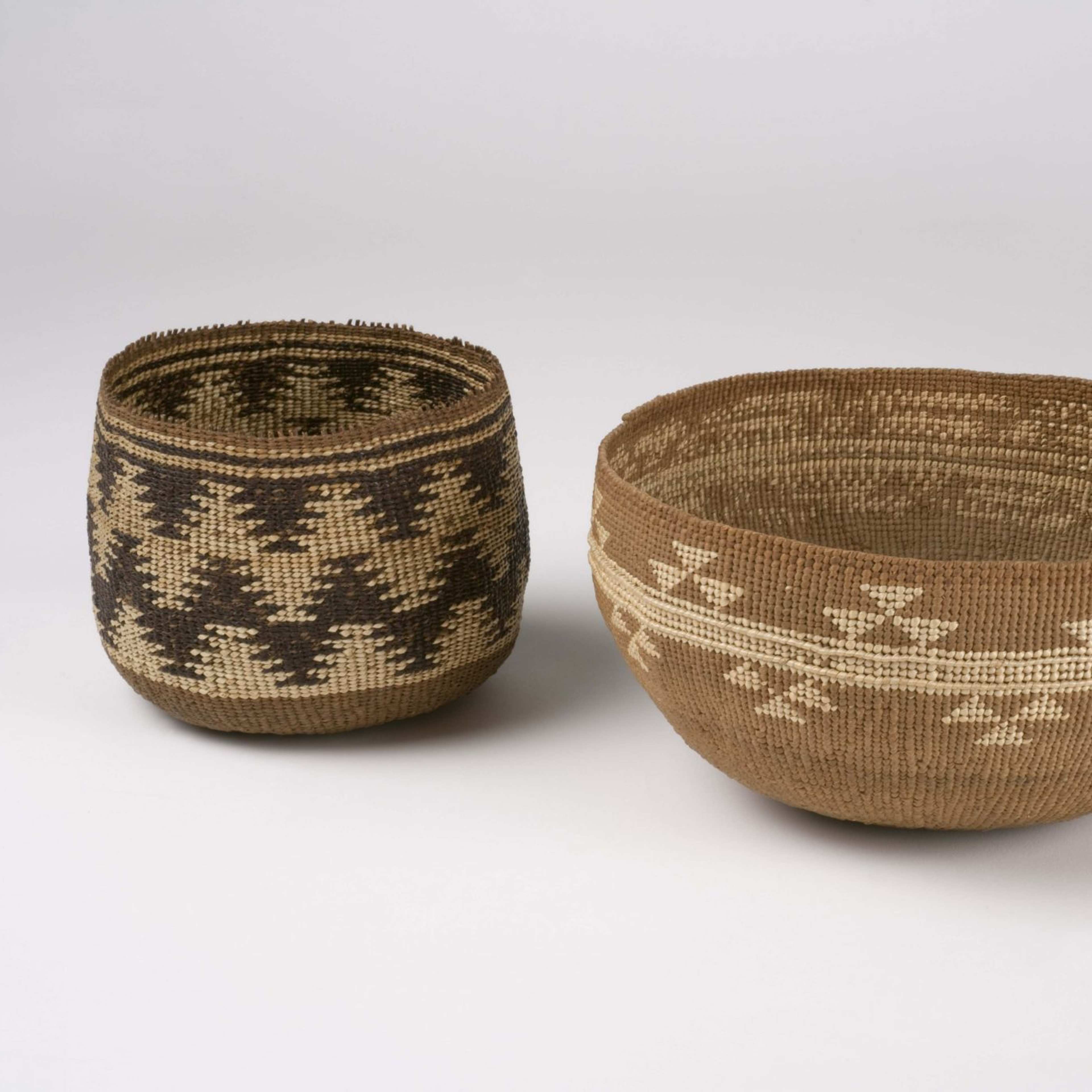 A photograph of two woven baskets with geometric patters