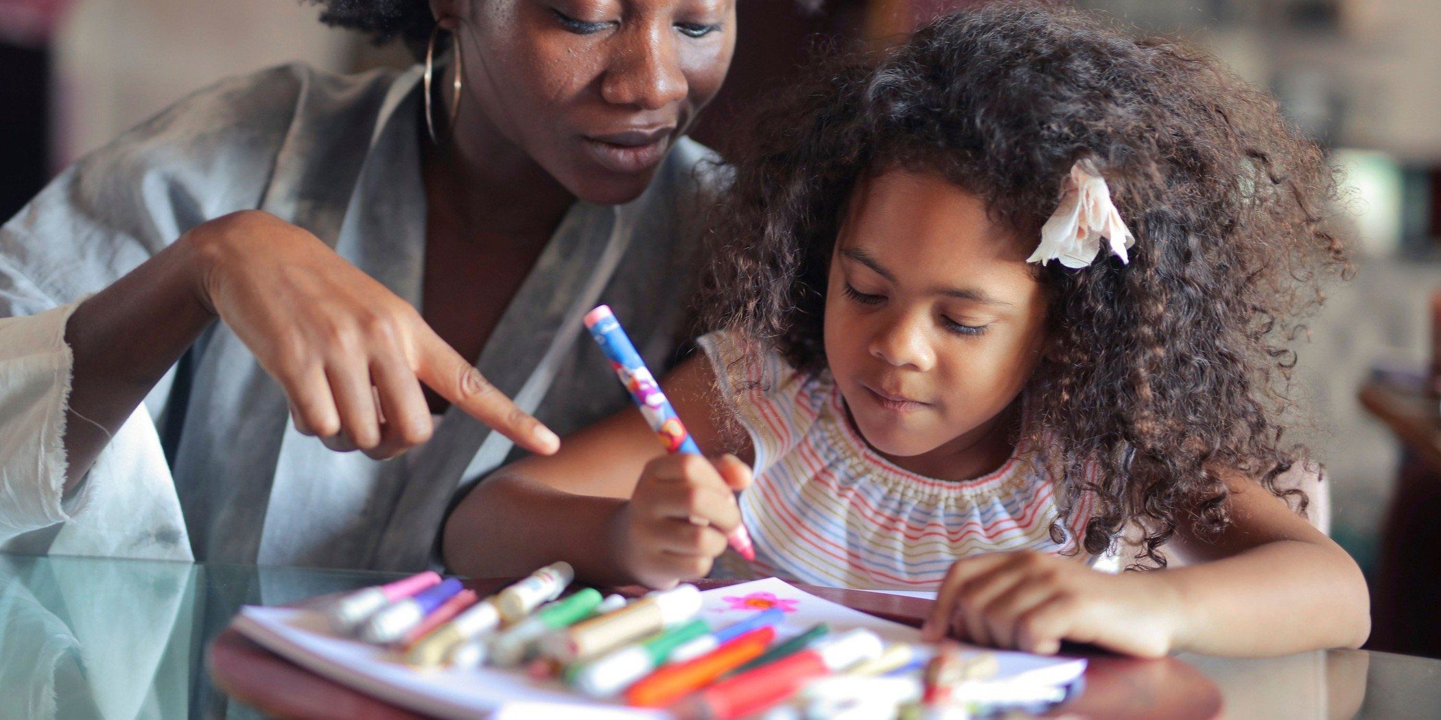 A child coloring with markers at the table