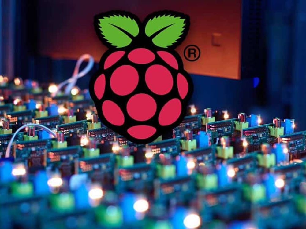 Rows of Raspberry Pi boards beneath a large Raspberry Pi logo.