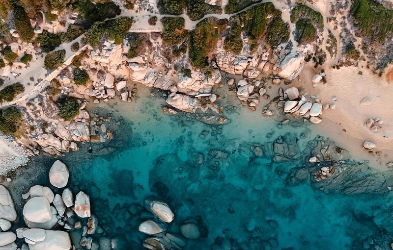 Aerial View of a Rocky Slope Above the Turquoise Sea, Porto Pollo