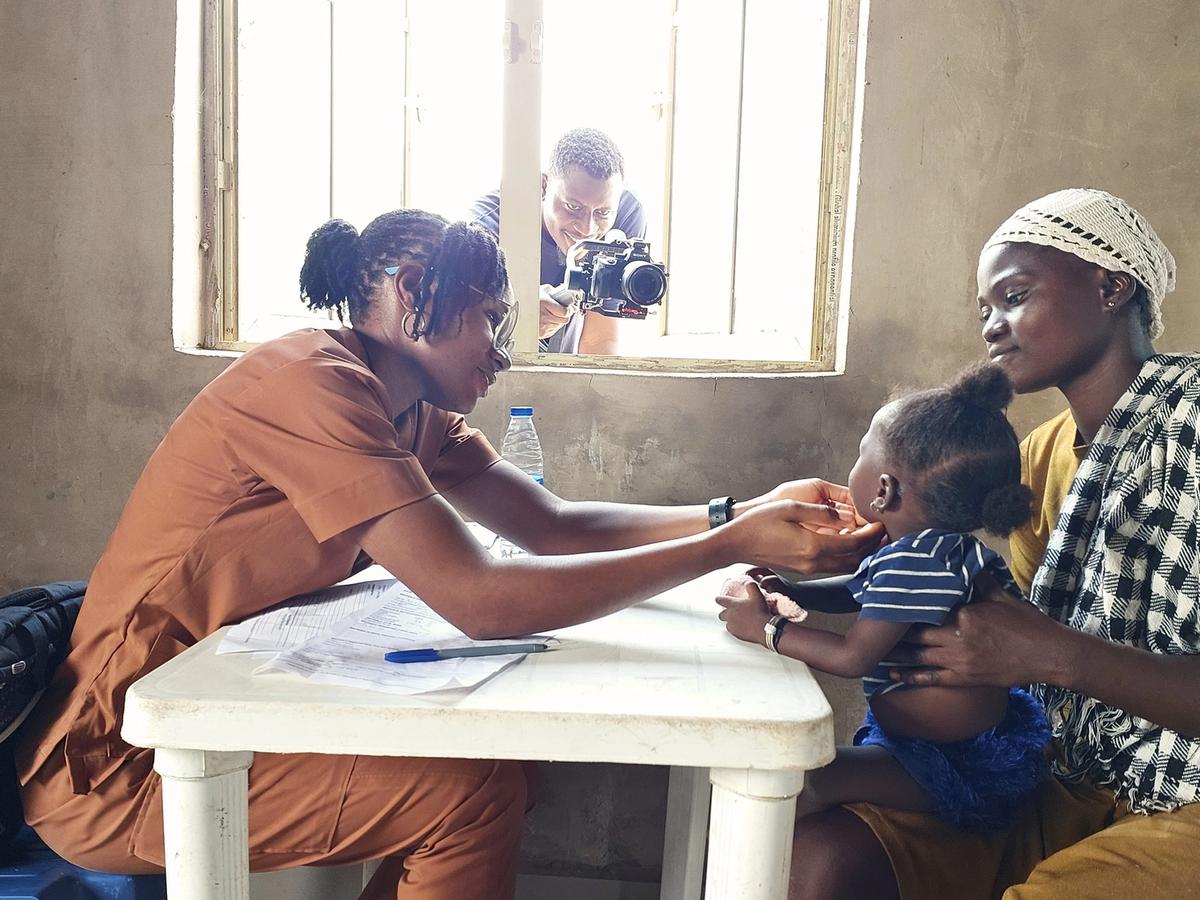 A clinician attending to a child during the Kunyami Health Outreach