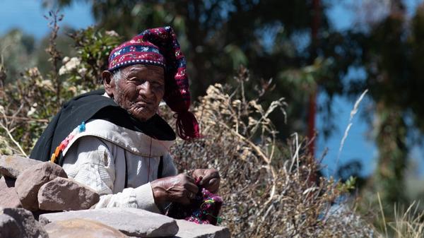 Peruvian man knitting