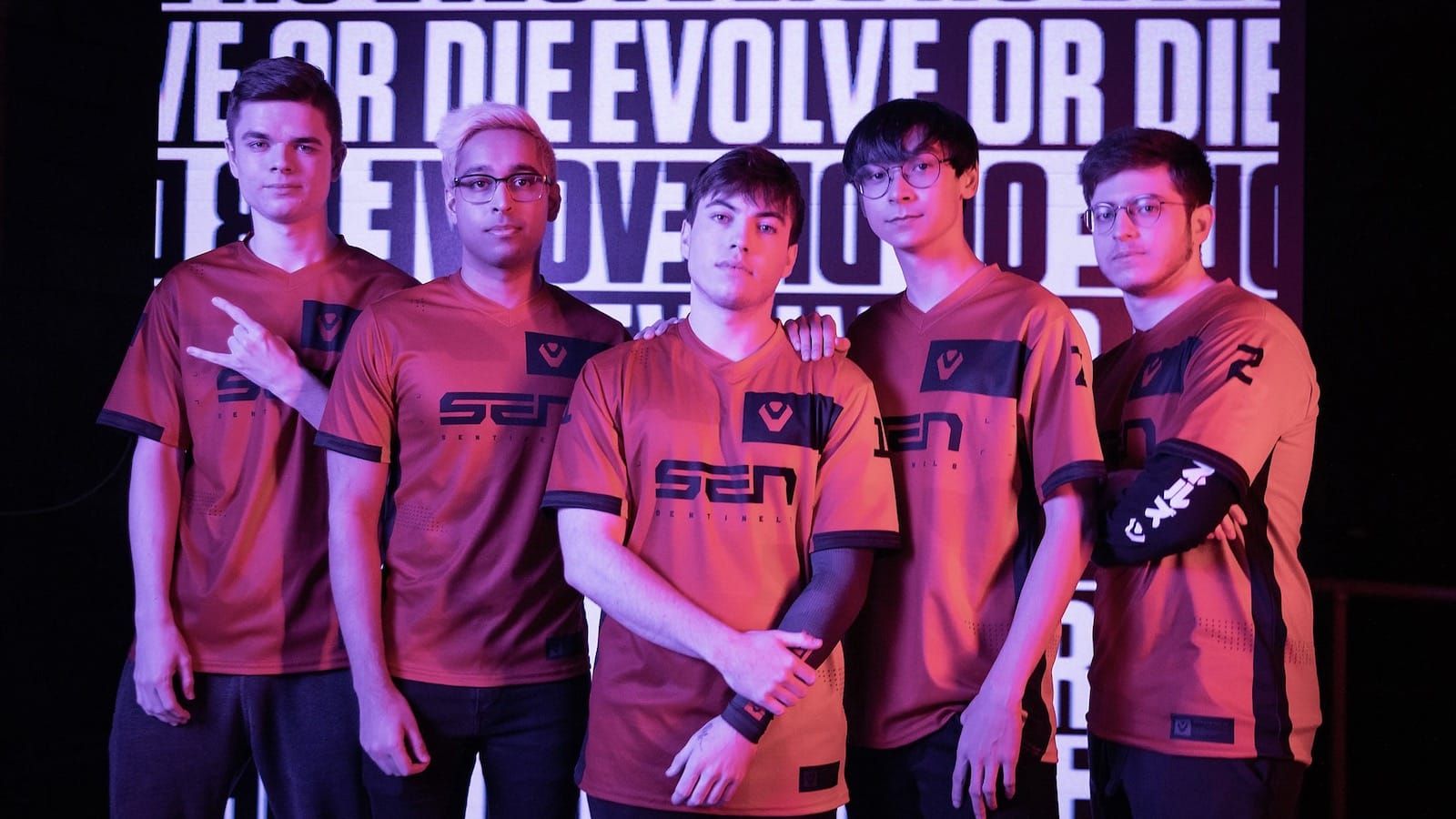 Sentinels Valorant team standing in front of background that says "Evolve or Die"