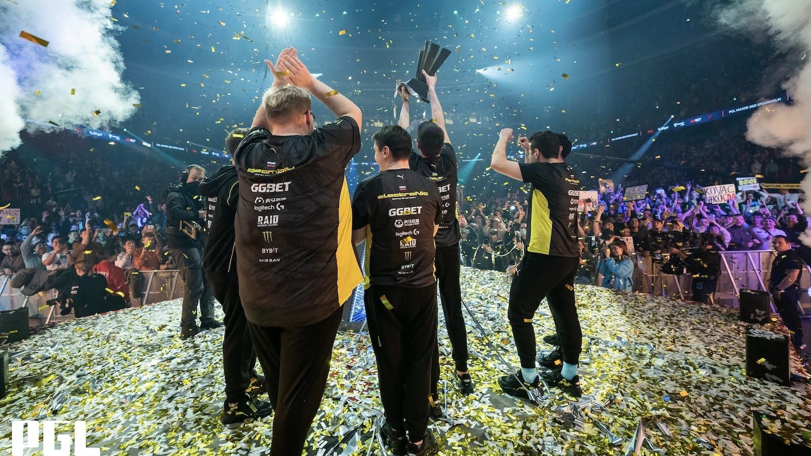 CS:GO team Natus Vincere lift the trophy at PGL Major Stockholm as confetti falls and crowd cheers