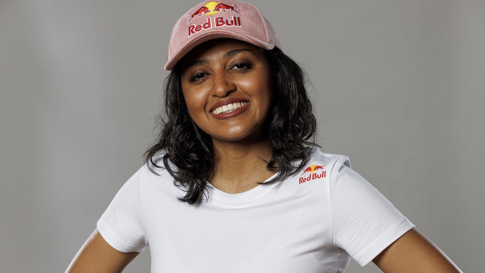 Headshot photo of Tekken player Cuddle_Core who is smiling and wearing a white t-shirt and Red Bull hat