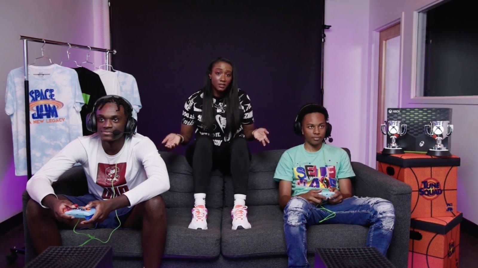 3 Black gamers on a couch participating in Community's esports event