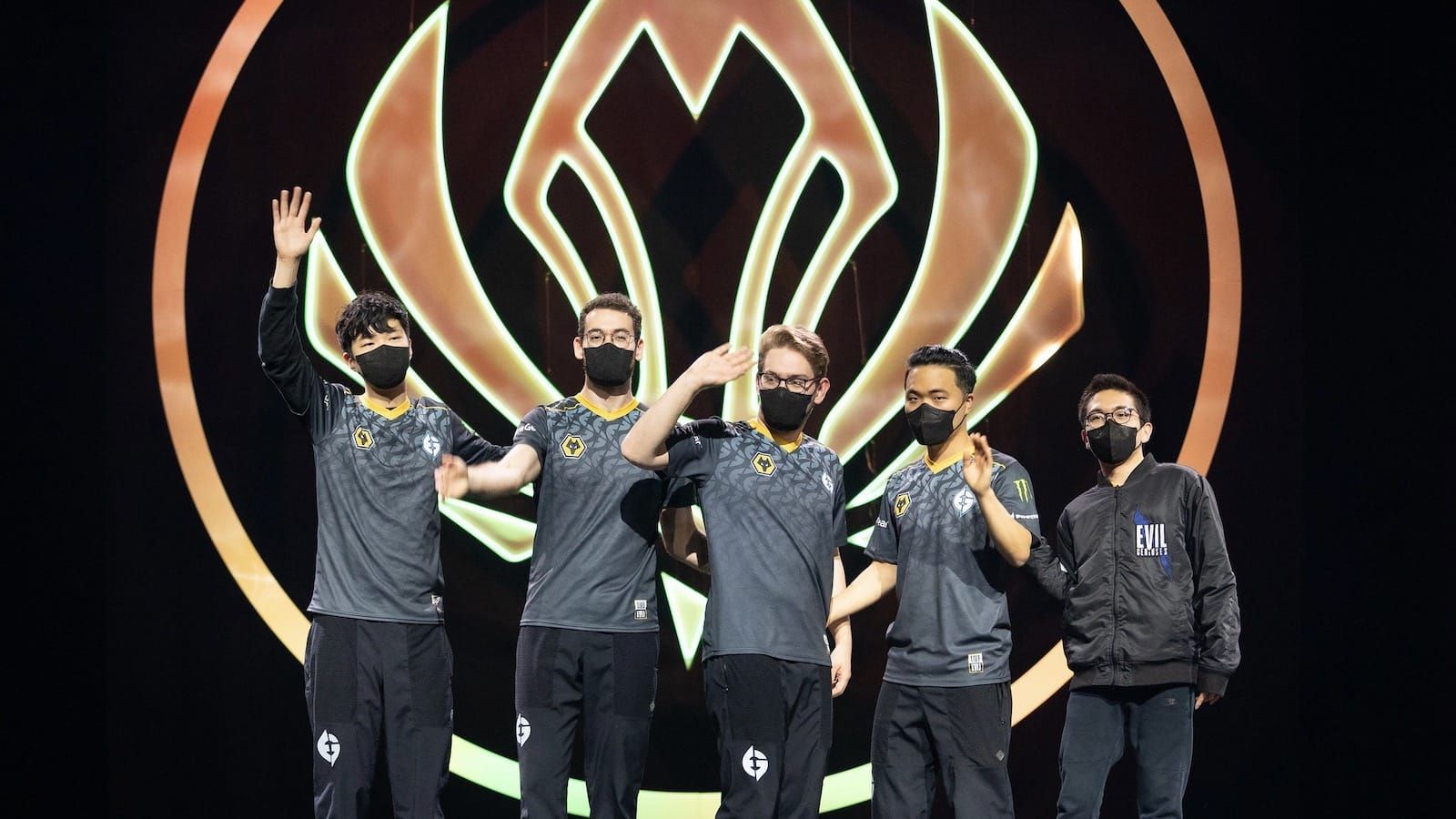 Evil Geniuses League of Legends team waves to the crowd after win while standing on stage in front of giant MSI logo