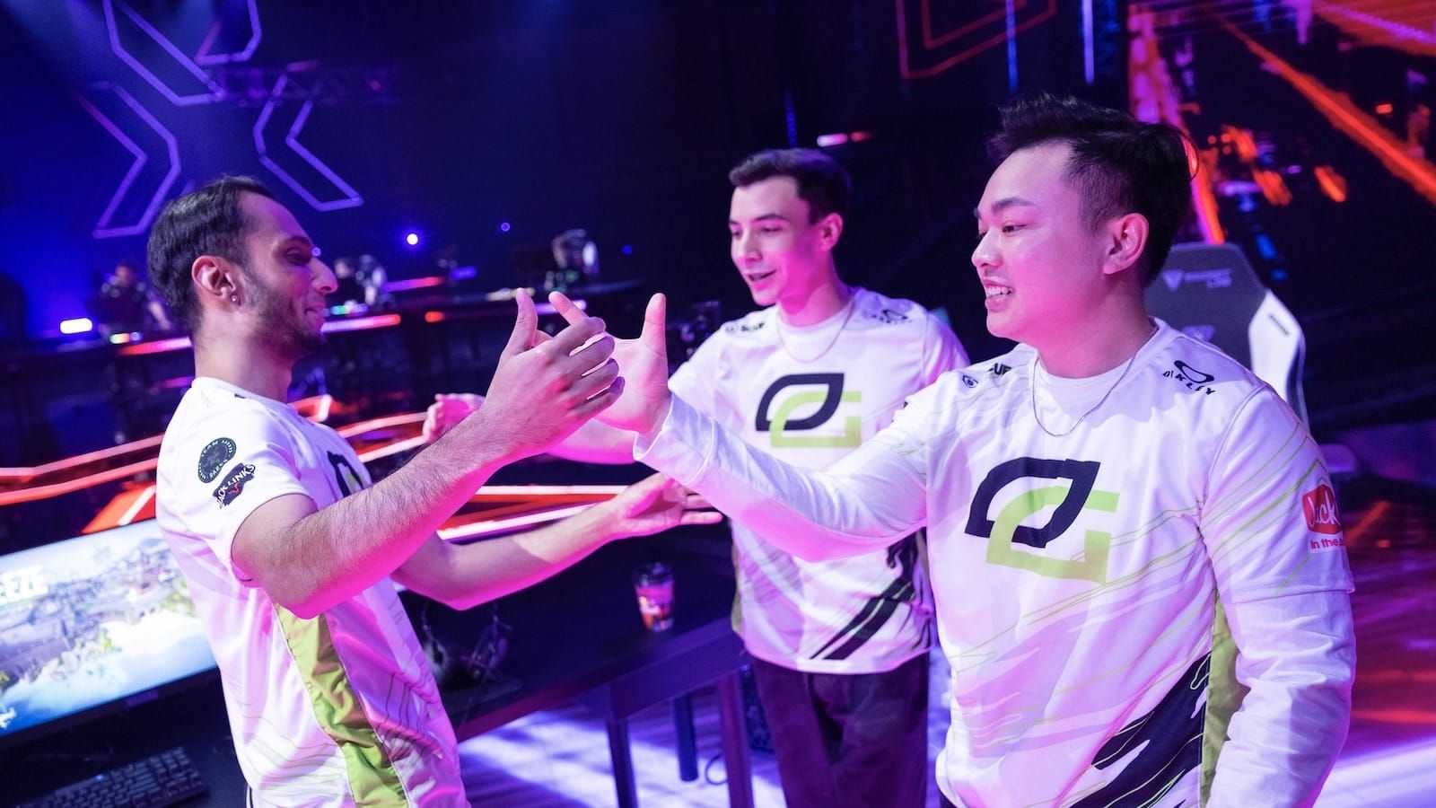 Optic Gaming Valorant players FNS, cashies and Victor high five each other on stage after a victory
