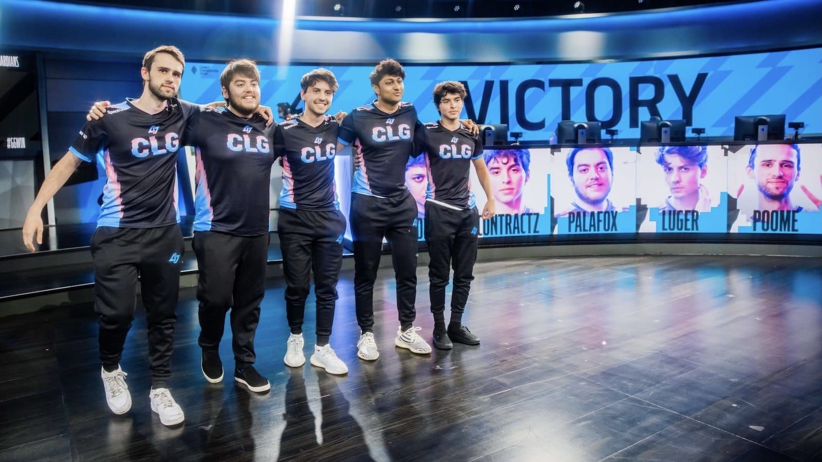 CLG League of Legends team stands on stage smiling after victory