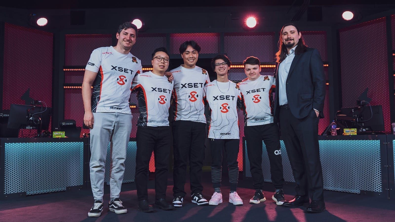XSET Valorant team pose for a photo onstage at a tournament