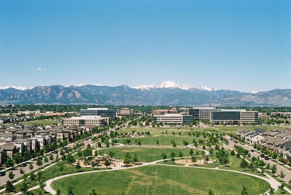 Aurora Colorado city view with Rocky Mountains and snow-capped peaks in background